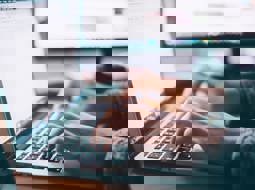 A close up of a male hands using a computer