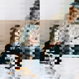 two women looking at computer at home