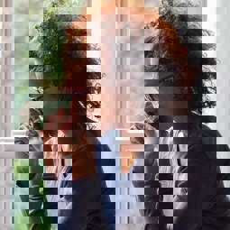 sad woman beside window