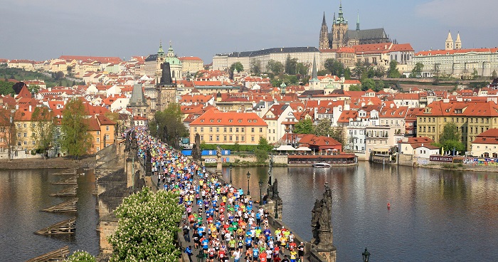 Runners over bridge and city backdrop