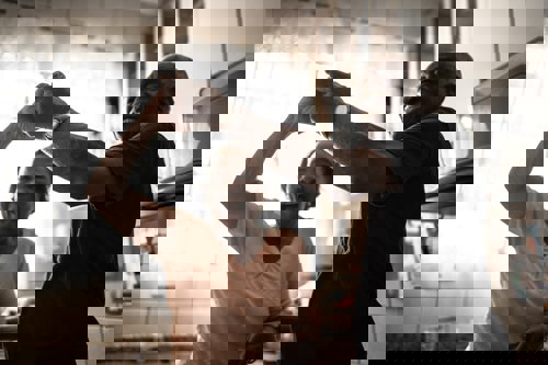 Smiling black couple dancing in kitchen