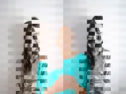 Smilng woman looks down at phone