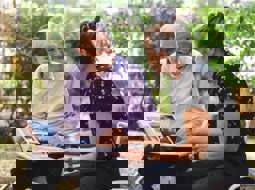 Smiling older man and woman looking at photo album