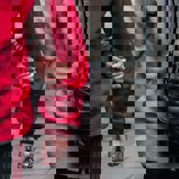 close up two people wearing fleeces linking arms