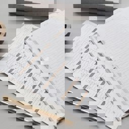 pile of papers on a desk with a pen