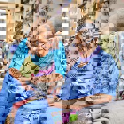 Carer Jaycee with Mum doing puzzles, smiling and chatting